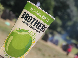 Brothers Festival Apple cider cup with blurred outdoor festival background