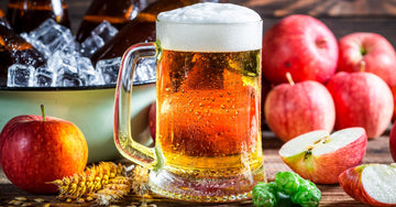Pint of beer with cider apple on a table