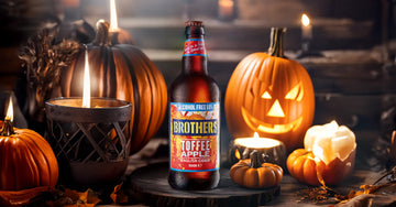 Toffee Apple Alcohol-Free Cider amongst Halloween pumpkins and candles