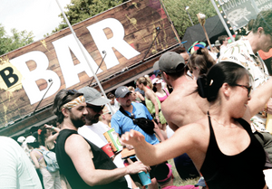 People at a music festival with the Brothers B-bar sign in the background