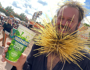 Man with spaghetti beard and Brothers Festival Apple at Glastonbury Festival