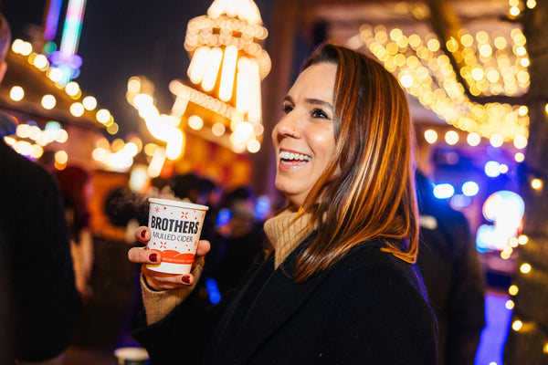 Lady enjoying a Brothers Mulled Cider at Hyde Park Winter Wonderland