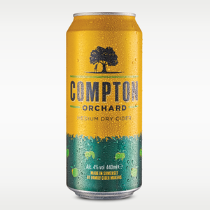 A single can of Compton Orchard Cider on a light gray gradient background. The can is bright yellow on the upper half and dark green on the lower half, covered in condensation droplets.