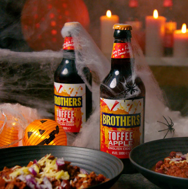 Bottles of Toffee Apple cider at Halloween party and decorations